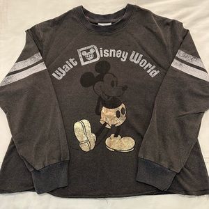 Distressed black Walt Disney World varsity-style long sleeved shirt.